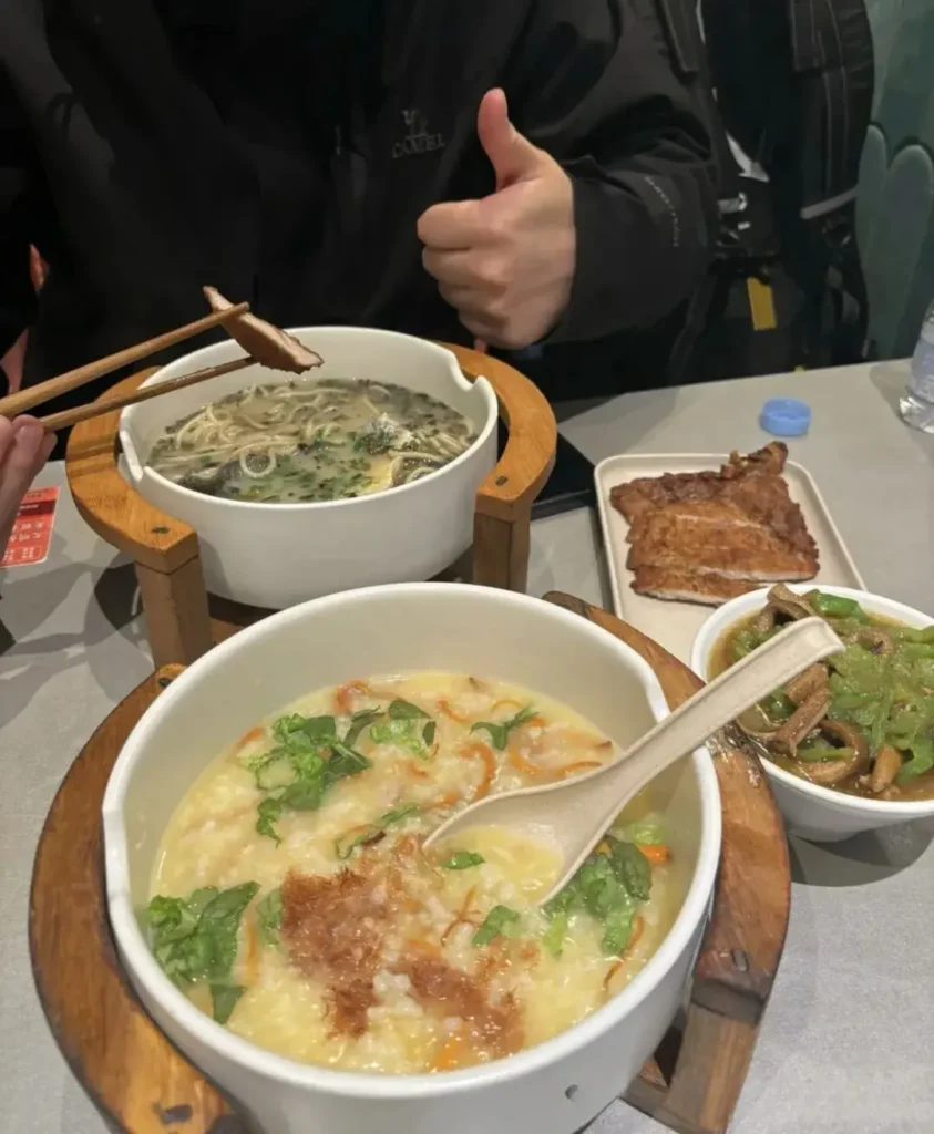 Shanghai Dingtel Congee & Noodle Restaurant's braised noodles with pickled mustard greens and small yellow croaker, and fried pork chops