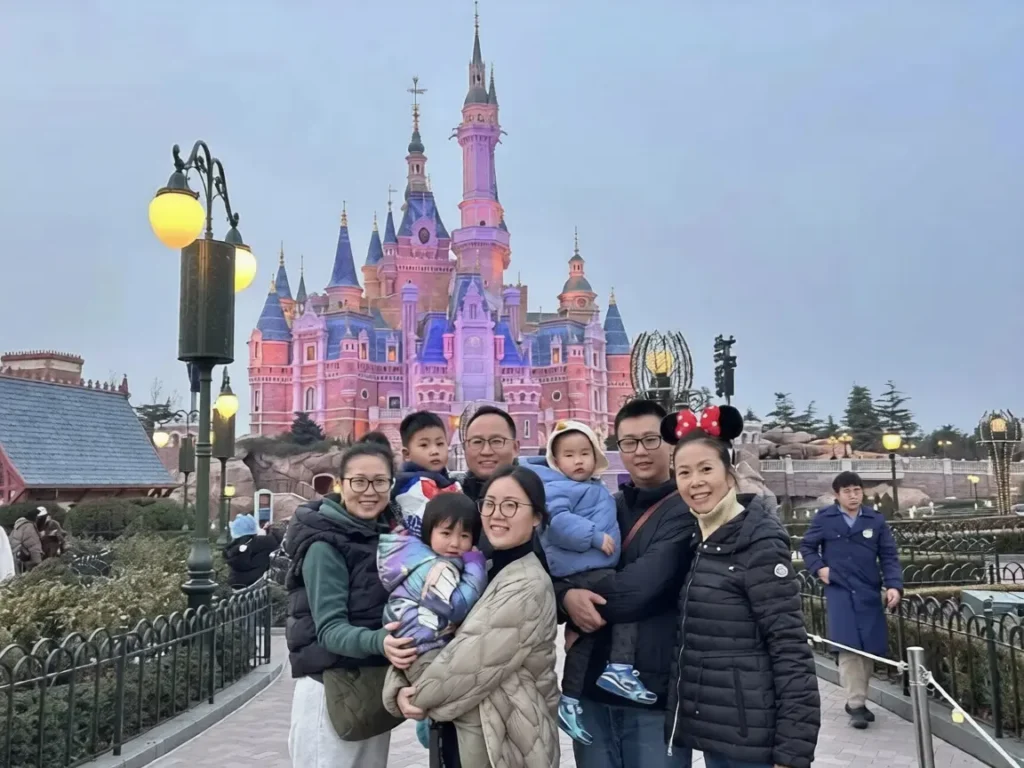Family enjoying shanghai disneyland park attractions parade